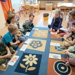 Grupa dzieci siedzi układa obrazki