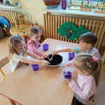 Dzieci sadzą rośliny do małych doniczek